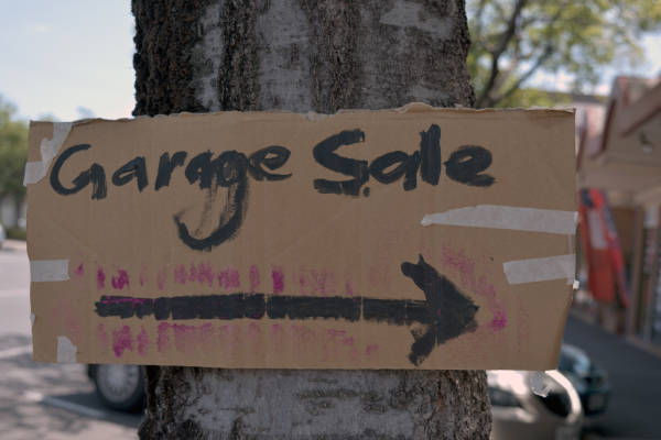 Hand Made Garage Sale Sign Taped To Tree