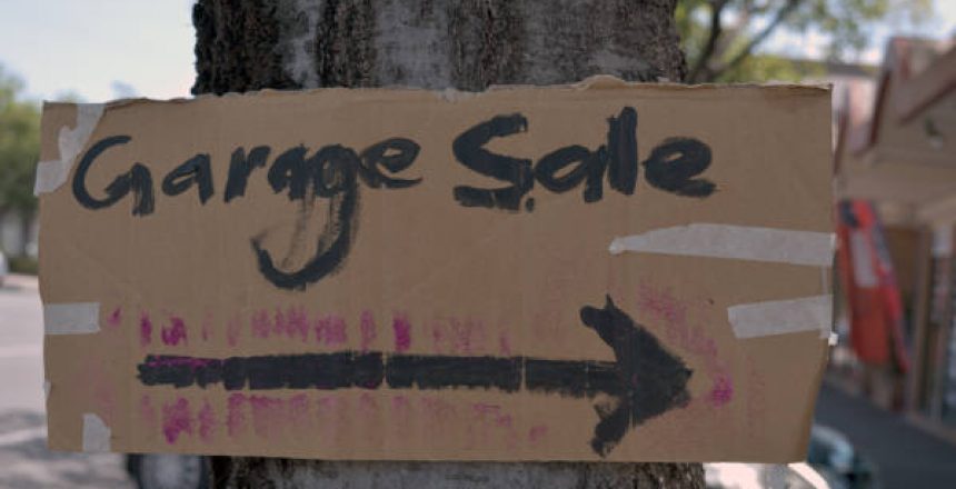 Hand Made Garage Sale Sign Taped To Tree